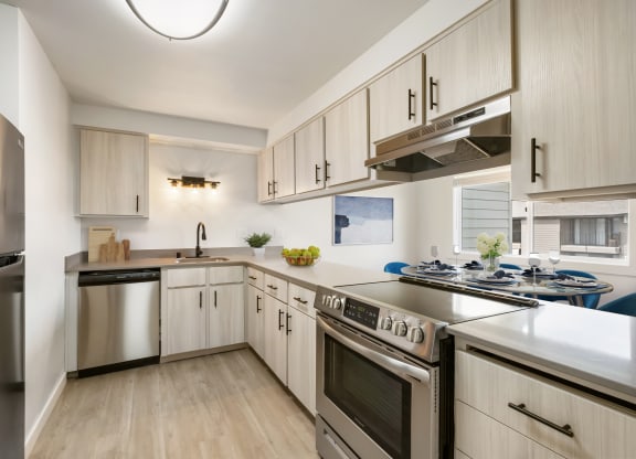 a kitchen with white cabinets and stainless steel appliances  at Brix, Walla Walla, WA, 99362