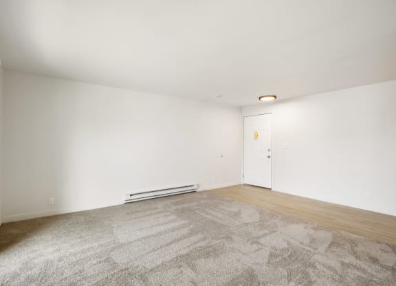 a living room with carpet, faux wood floors and white walls  at Brix, Washington