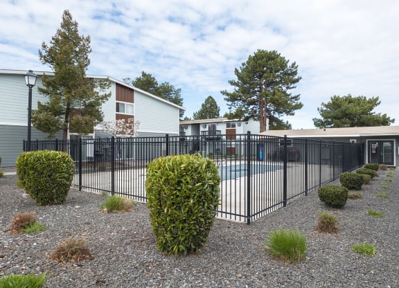 A swimming pool that's surrounded by a black wrought iron fence at Wildflower, Washington