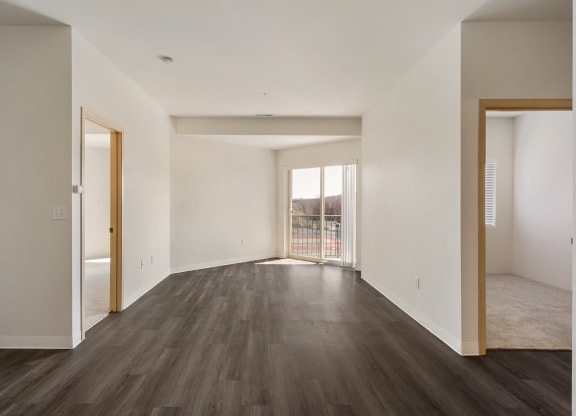 Open living room with hardwood flooring, white walls and filled with natural light.at Shoreline Village, Richland, WA