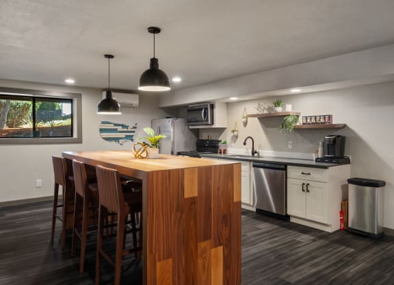 a kitchen with white cabinets and a wooden island with a wooden countertopat Cedarwood, Wenatchee, WA