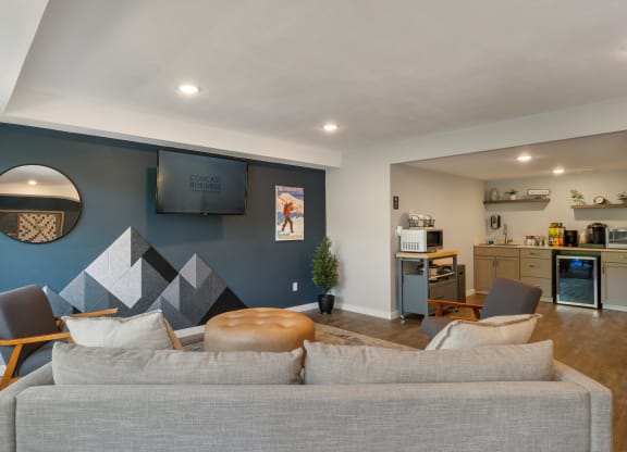 a living room with a couch and a chair in front of a wall with a tv on at Castlerock, Wenatchee Washington