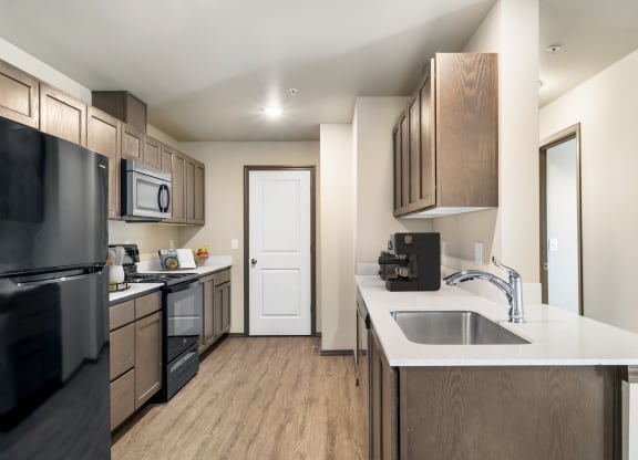 a kitchen with wooden cabinets and a white counter top  at Altitude, East Wenatchee, WA