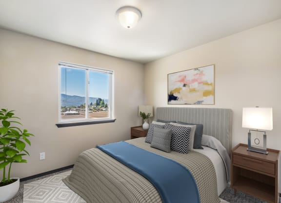 a bedroom with a large bed and two night stands with lamps  at Altitude, East Wenatchee, WA, 98802