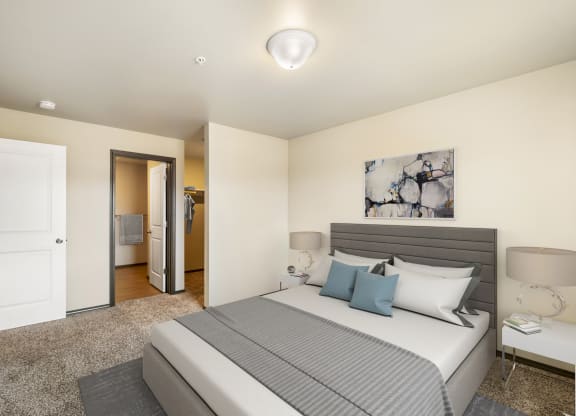 a bedroom with a large bed and a door to a bathroom  at Altitude, East Wenatchee, Washington