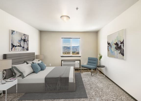 a bedroom with a bed and a chair in a 555 waverly unit  at Altitude, East Wenatchee