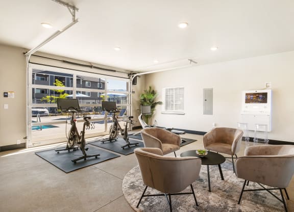 a resident fitness center with exercise machines and chairs  at Altitude, East Wenatchee, 98802