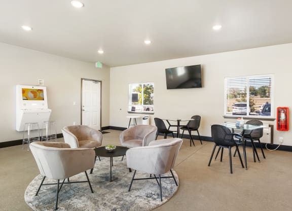 a room with chairs and a table with a television on the wall  at Altitude, East Wenatchee, WA