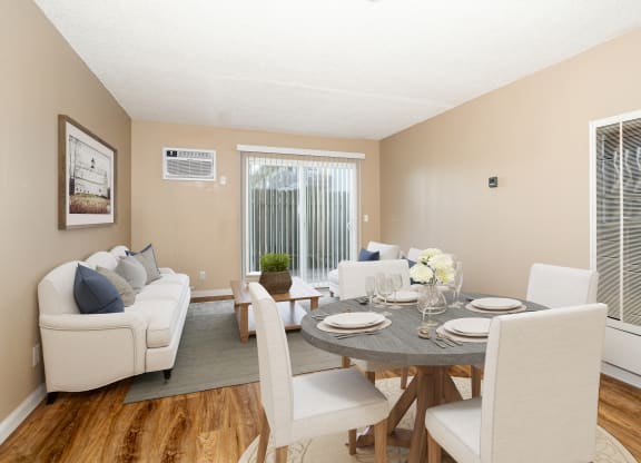 a living room and dining room with a table and chairs