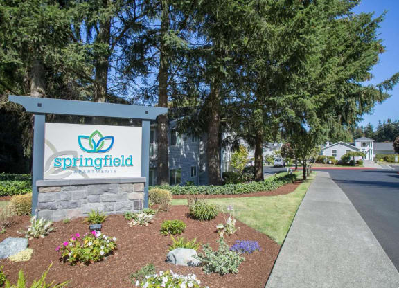 Exterior entry with trees and other plants.  There is a Springfield welcome sign.at Springfield, Renton, WA