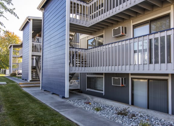 Exterior view of rock path and buildings at The Lakes Apartments, Moses Lake, WA.