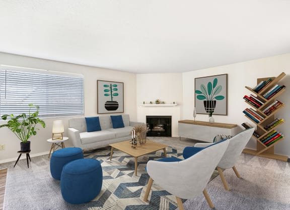 Living room with a large window on the left wall, a fireplace, and mantle in the center staged with a couch, chairs, and coffee table.at Capitol Crossing, Olympia, WA 98501
