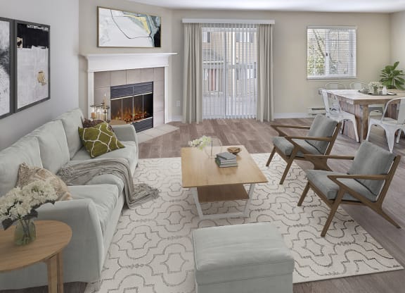 Apartment living room with a wood burning fireplace and staged furniture. Right off the living room are doors to the outdoor patio at Arterra Apartments, Kent, 98030