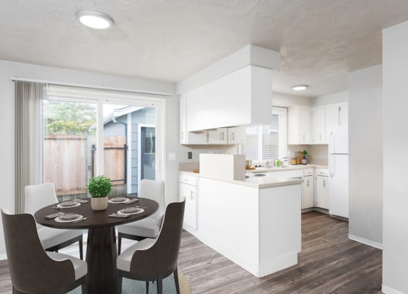 an open kitchen and dining room with a table and chairs
