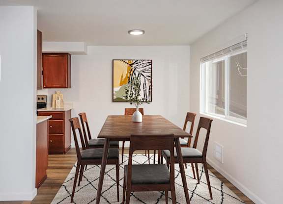 a kitchen and dining area with a carpeted floor and large window at Heritage Grove Apartments in Renton, WA