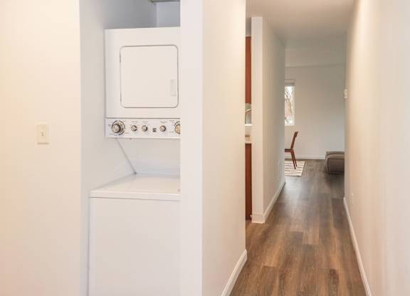 A long hallway with a washer and dryer to the left at our apartments for rent in Renton, WA