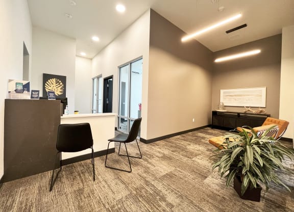 an empty office with a table and chairs and a reception desk at The Duo, University Place Washington