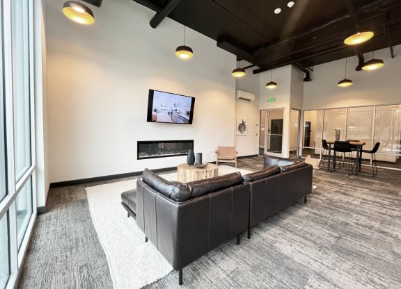 a large living room with a leather couch and a tv at The Duo, University Place, WA 98466 
