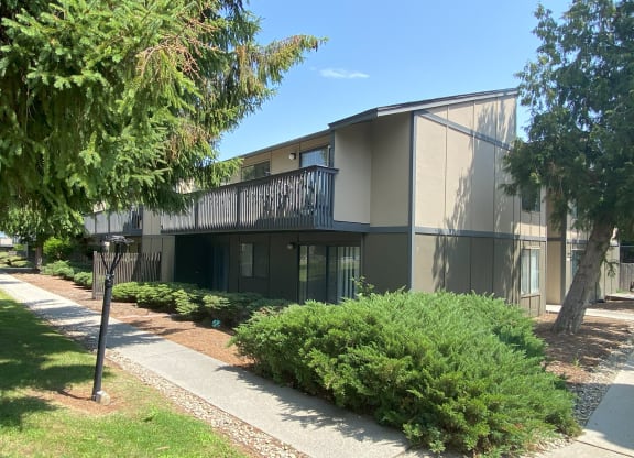 a building with a balcony and a sidewalk in front of it at Cedarwood, Washington