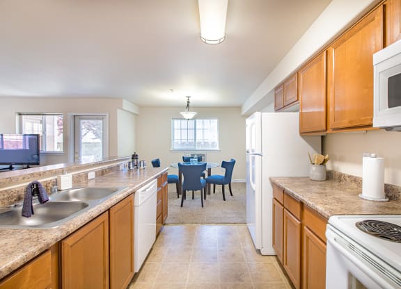 a kitchen and dining room with a table and a microwave  at Quail Springs, West Richland