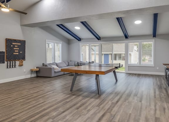 a living room with a ping pong table and a couch  at Kirkwood Meadows, Pocatello