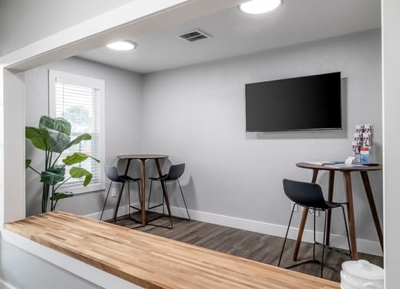 a living room with a table and chairs and a television at Kirkwood Meadows, Pocatello, ID 83201