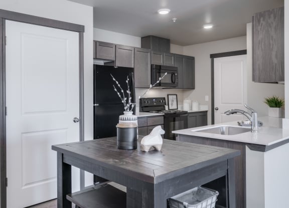 Dining area looking into Kitchen. Dining area has a small bar stool table and chairs. at Altitude, East Wenatchee, WA