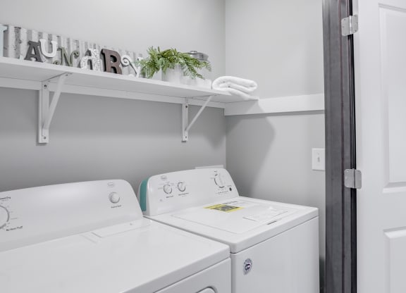 Closet with side by side full sized washer and dryer and upper storage. at Altitude, East Wenatchee, 98802