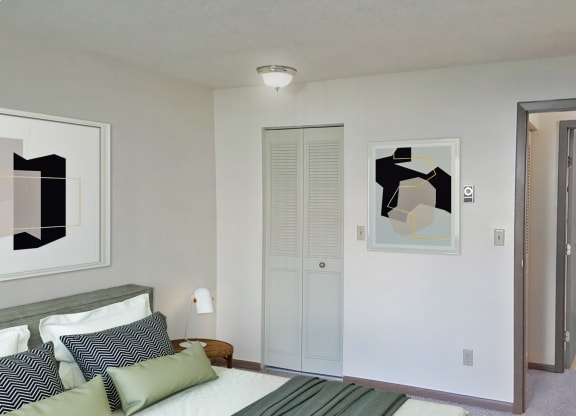Bedroom corner with bed, closet, and door leading to the hallway and bathroom from left to right.at Laurel Park, Twin Falls, Idaho