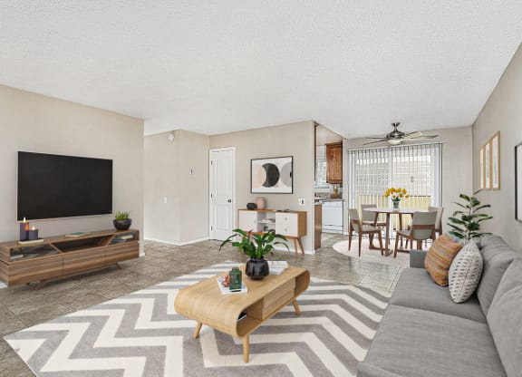 Apartment entrance leading into the living room with a large couch, coffee table and entertainment center with TV at Pacific Sands, San Diego, CA, 92117