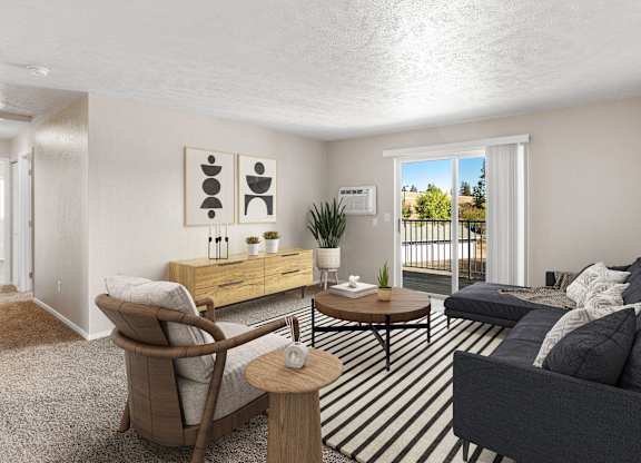 A living room with a grey couch, a wooden chair, and a coffee table at The Overlook Apartments in Post Falls, ID.
