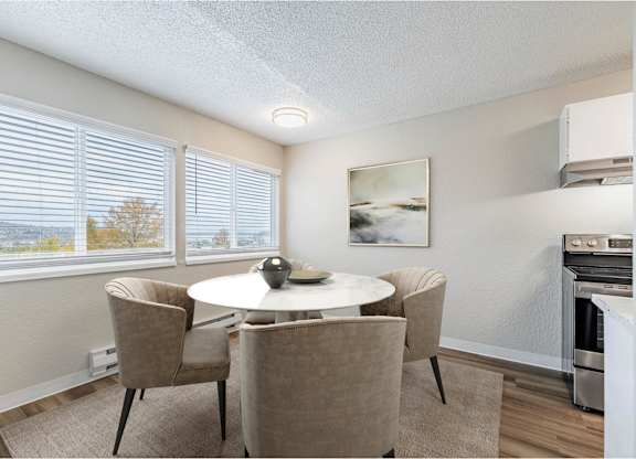 Dining area at Peak 88 Apartments in Renton, WA with table seating and open layout