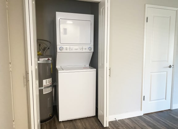 Washer and dryer in hallway off kitchen and living room