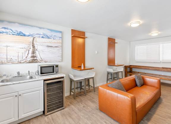 Resident Lounge with a couch and a kitchen with a sink and a counter top at Rock Creek, Billings Montana