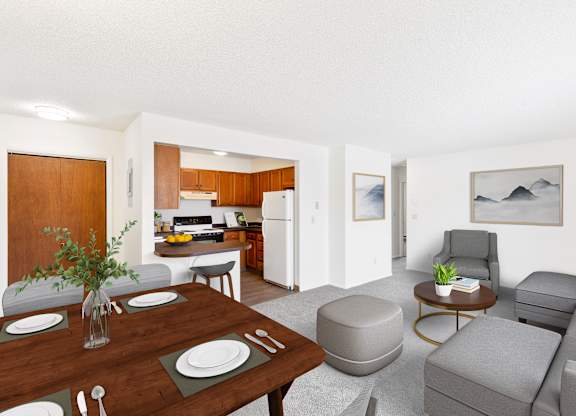 A modern living room with a dining table set for two. at Rock Creek in Billings, MT.