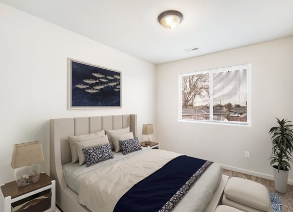 Bedroom with gray carpets, a large window with blinds on the right wall. Staged with bed, side tables, art, and house plant. at Pine Tree Park, Washington