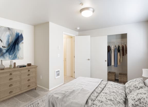 a bedroom with a bed and a closet with a mirror