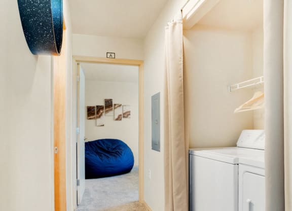 a washer and dryer in a room with a closet and a bed at Sky Vue, Washington