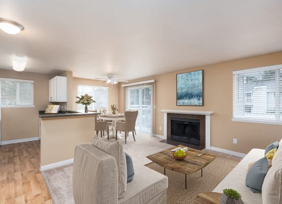 a living room with a fireplace and a dining room and kitchen