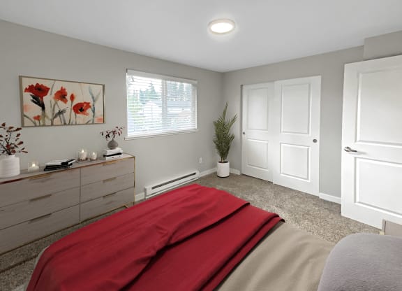 Bedroom with gray carpet, double sliding door closet, large window with blinds staged with dresser, wall art, a bed, and plant.at Quilceda Gardens, Marysville