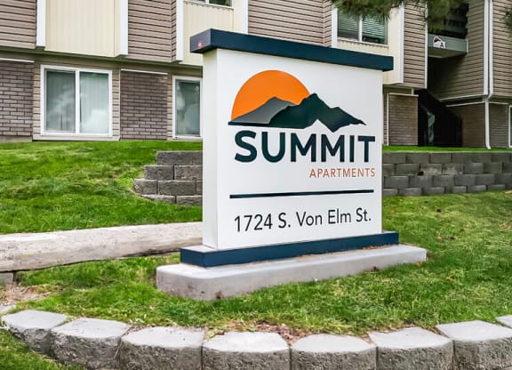 a sign for summit apartments in front of a building at Summit, Idaho, 83201
