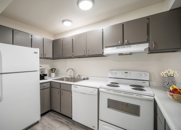 a kitchen with white appliances and gray cabinets at Summit, Pocatello, 83201