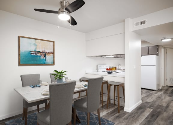 a dining room and kitchen with a table and chairs