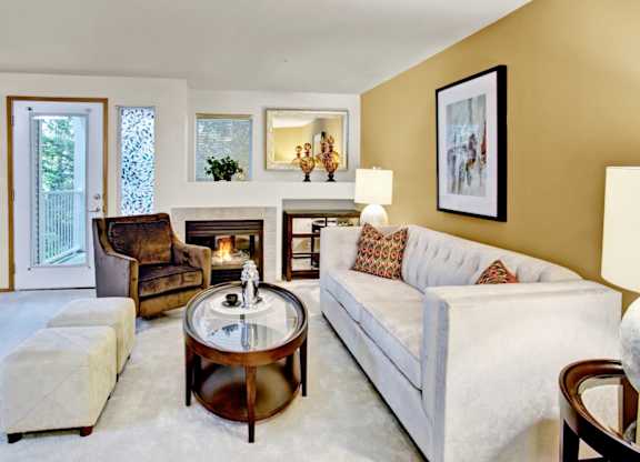 A living room with a white couch and a coffee table.