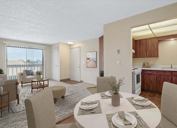 Open dining area with four-seat table next to the living room in a 2 bed 1 bath floor plan at the Lakes in Moses Lake