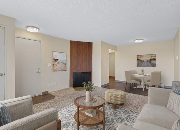 Living room with fireplace and adjoining dining area in a 2 bedroom apartment at The Lakes in Moses Lake, WA