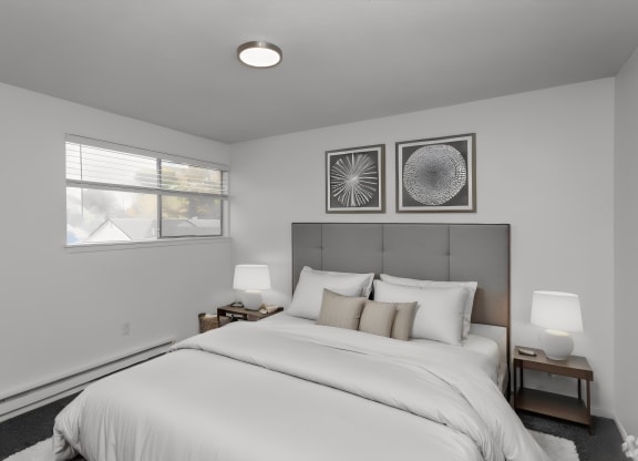 bedroom with white walls and a white bed with white sheets and pillows