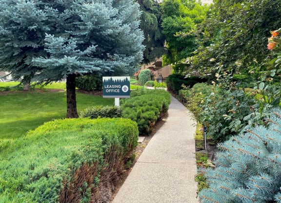 a sidewalk with a sign in that reads leasing office at Castlerock, Wenatchee Washington