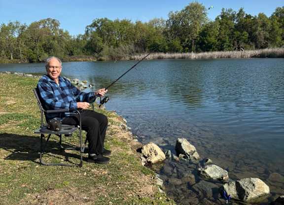 A man is fishing at Lodi Commons Senior Living, Lodi, CA