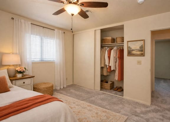 Bedroom with open closet and ceiling fan at Castle Vista Senior Duplex Community Apartments, Atwater, 95301